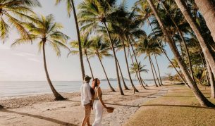 a couple walking on the Palm Cove Beach