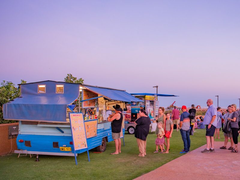 people lining up outside a food stall at Town Beach Night Markets, Broome
