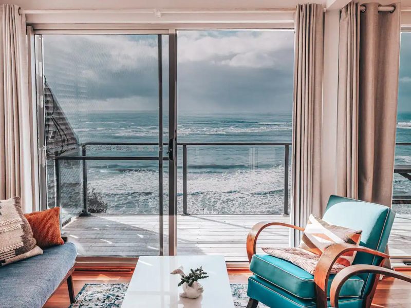 an oceanfront villa with glass windows facing the sea in Pacific Lodge, Yamba