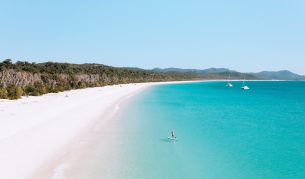 Stand up paddleboarder on Whitehaven beach.